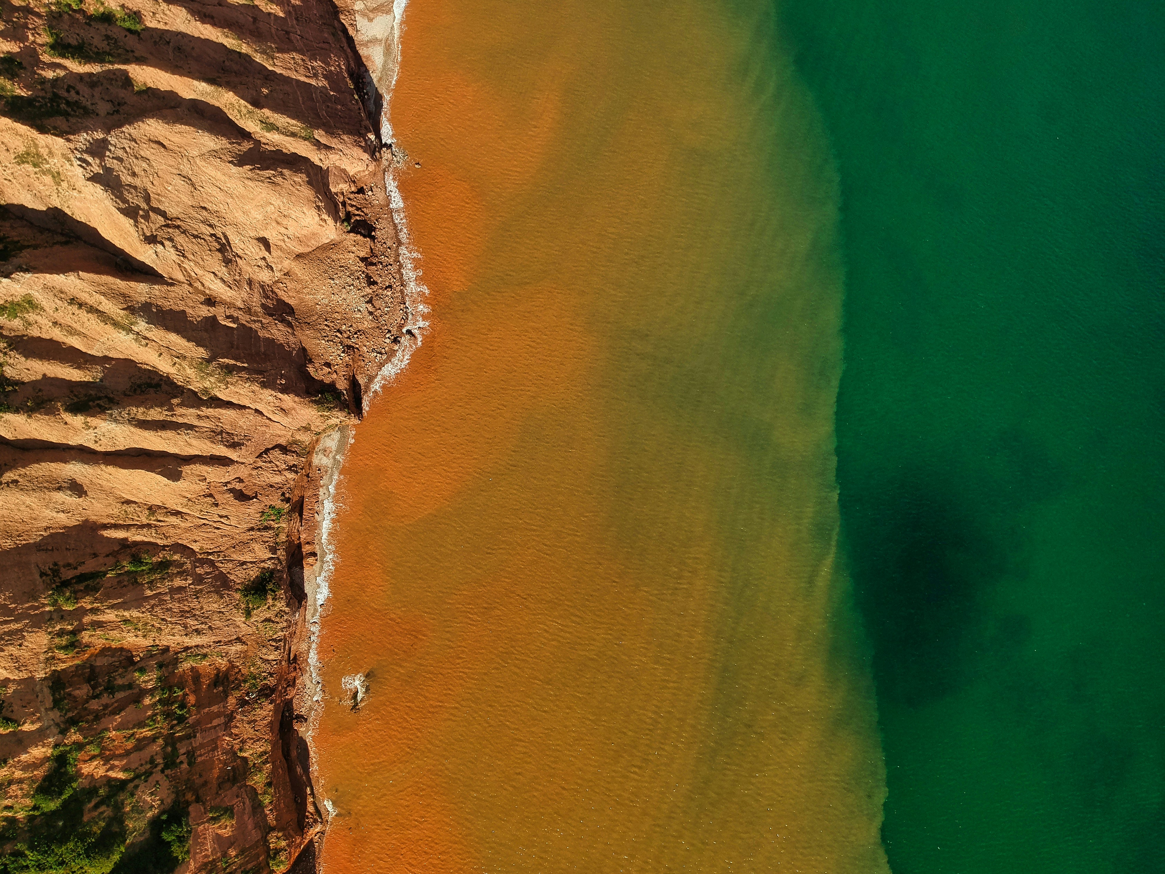 aerial view of brown and green sea